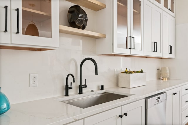 kitchen featuring white cabinetry, dishwasher, and decorative backsplash