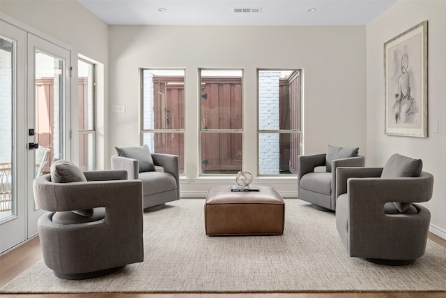 living room with a healthy amount of sunlight and hardwood / wood-style flooring