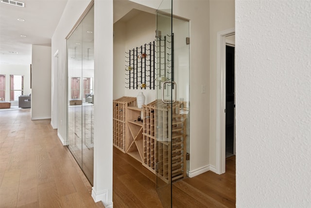 hallway with hardwood / wood-style floors