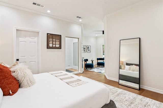 bedroom featuring ornamental molding and wood-type flooring