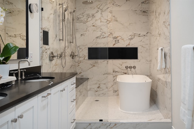 bathroom with vanity, tiled shower, and tile walls