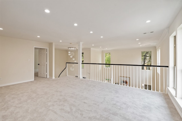 carpeted spare room featuring ornamental molding