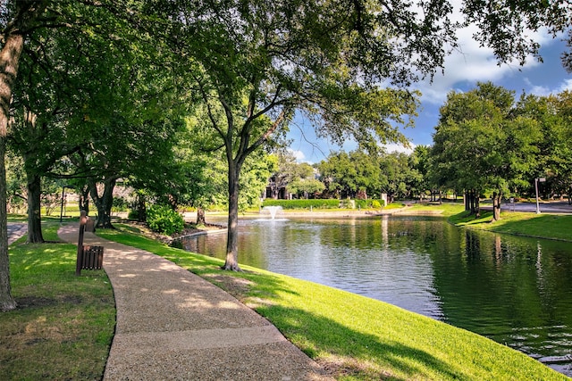 surrounding community with a yard and a water view