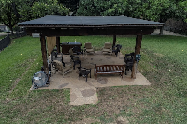 view of patio with area for grilling, a gazebo, and a fire pit