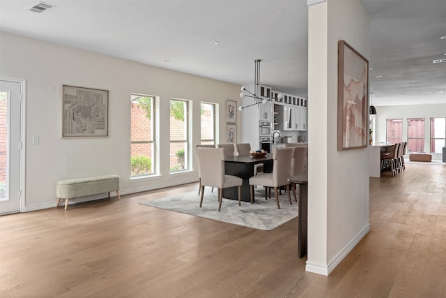 dining space featuring hardwood / wood-style flooring and sink