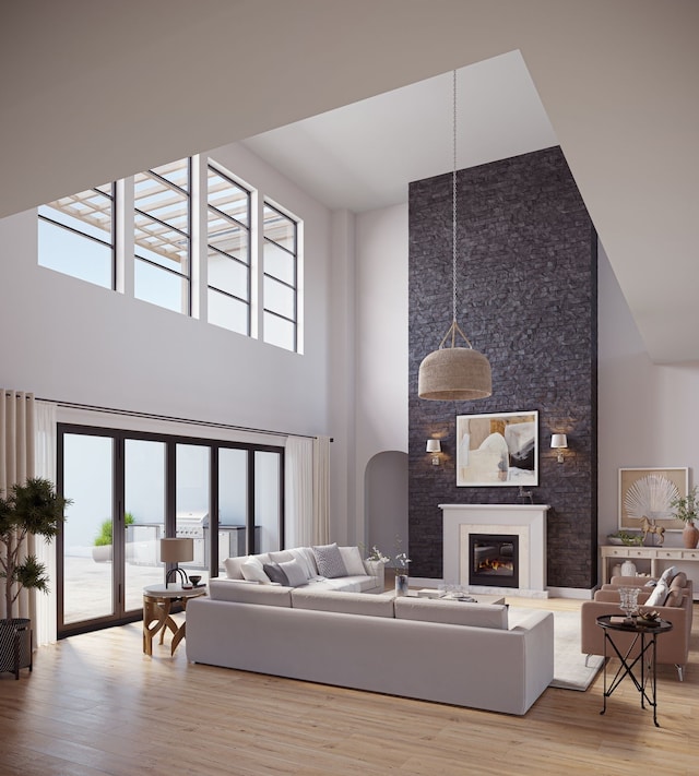 living room featuring a high ceiling and light hardwood / wood-style floors