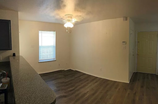 interior space featuring ceiling fan and dark wood-type flooring