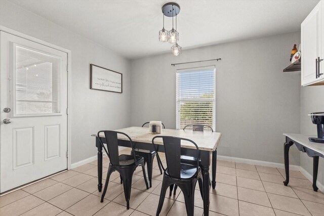 tiled dining space with sink and track lighting