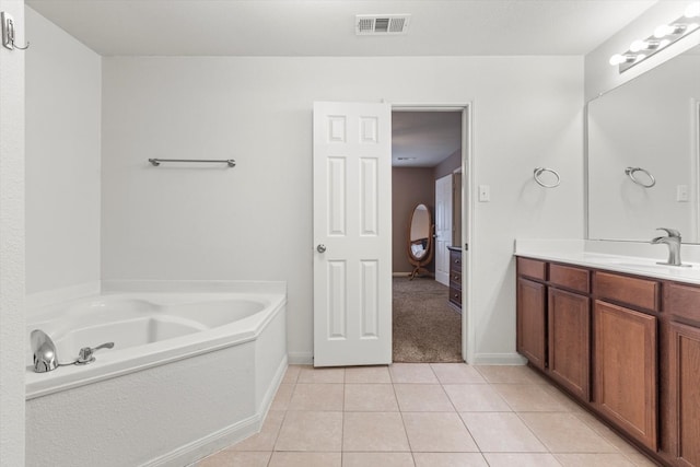 bathroom featuring tile patterned floors, vanity, and a bathtub