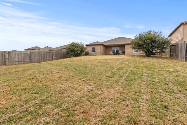 back of property with central air condition unit, a patio, and a yard