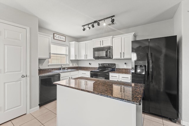 kitchen with white cabinets, black appliances, rail lighting, and light tile patterned floors