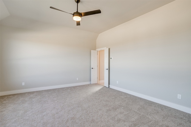 unfurnished room with ceiling fan, light colored carpet, and lofted ceiling