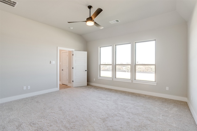 carpeted empty room with vaulted ceiling and ceiling fan