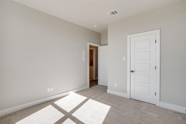 unfurnished bedroom featuring light carpet