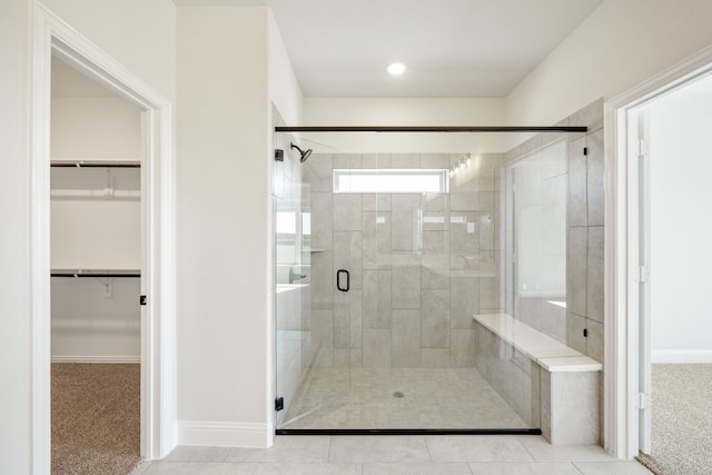 bathroom featuring tile patterned flooring and an enclosed shower