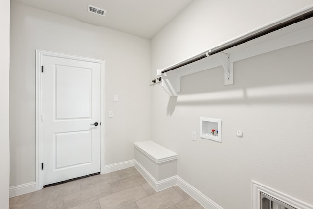 laundry area with hookup for a gas dryer, light tile patterned floors, and hookup for a washing machine