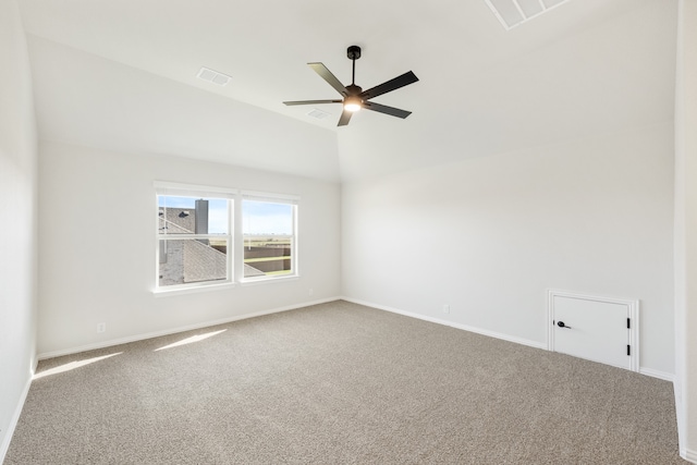 carpeted empty room with vaulted ceiling and ceiling fan