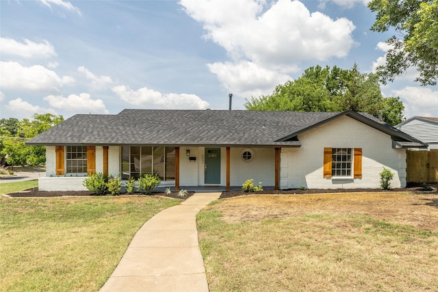 single story home with a porch and a front yard