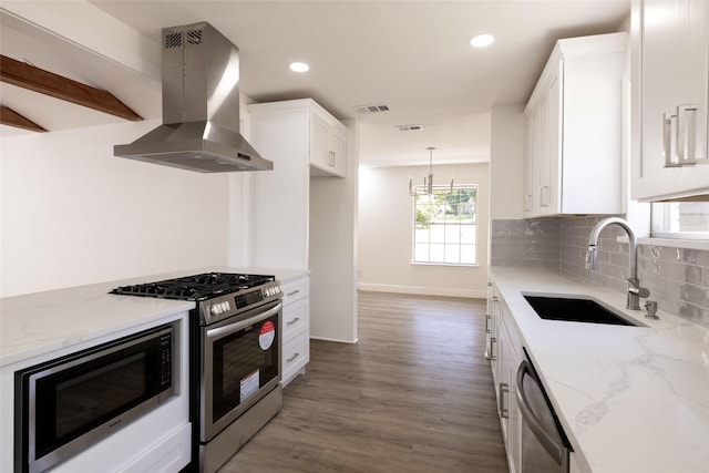 kitchen featuring light stone countertops, appliances with stainless steel finishes, sink, and island range hood