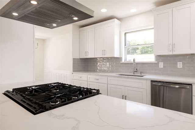 kitchen with sink, stainless steel dishwasher, white cabinets, and wall chimney exhaust hood