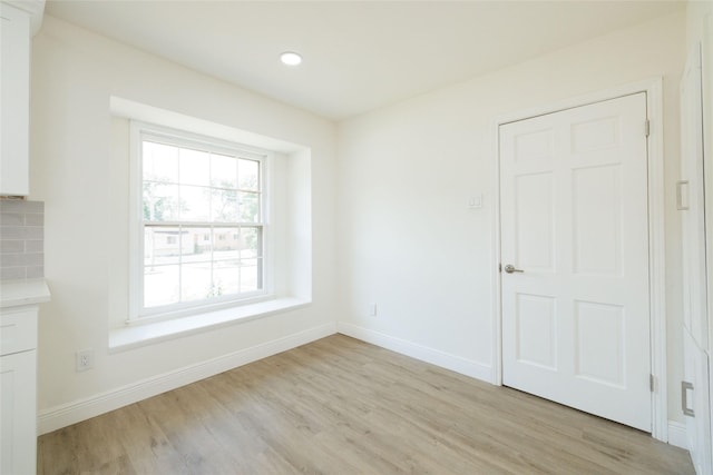 empty room with light wood-type flooring