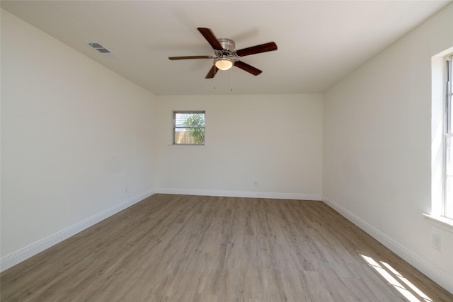 spare room featuring ceiling fan and light hardwood / wood-style flooring