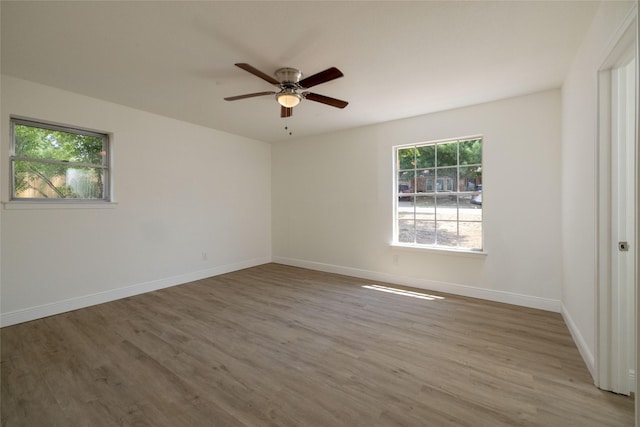 spare room with hardwood / wood-style flooring and ceiling fan