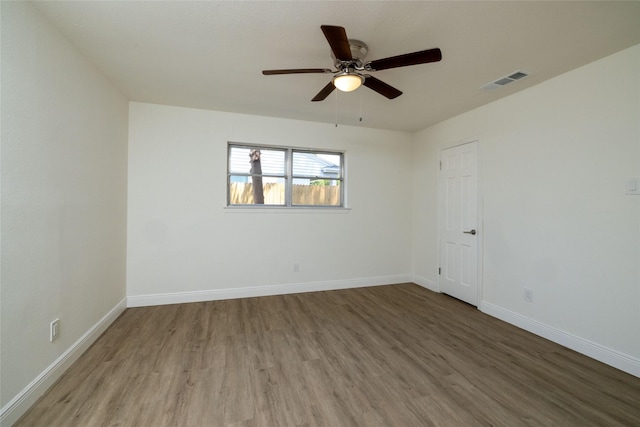 empty room featuring hardwood / wood-style flooring and ceiling fan