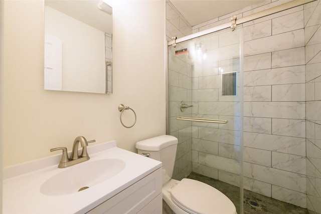 bathroom with vanity, a shower with shower door, and toilet