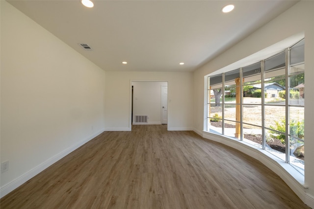 unfurnished room featuring hardwood / wood-style floors