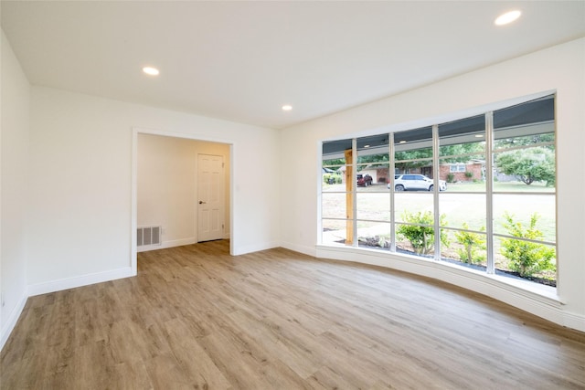 empty room featuring plenty of natural light and light wood-type flooring