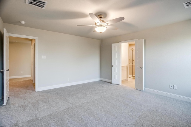 empty room featuring light colored carpet and ceiling fan