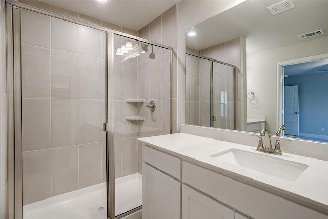 bathroom featuring vanity and a shower with door