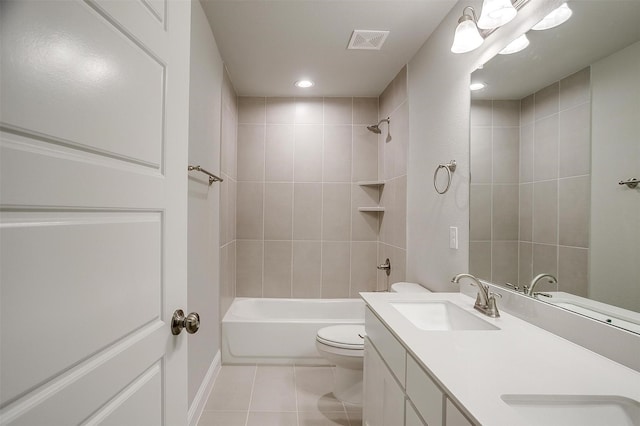 full bathroom with tiled shower / bath, tile patterned floors, toilet, and vanity