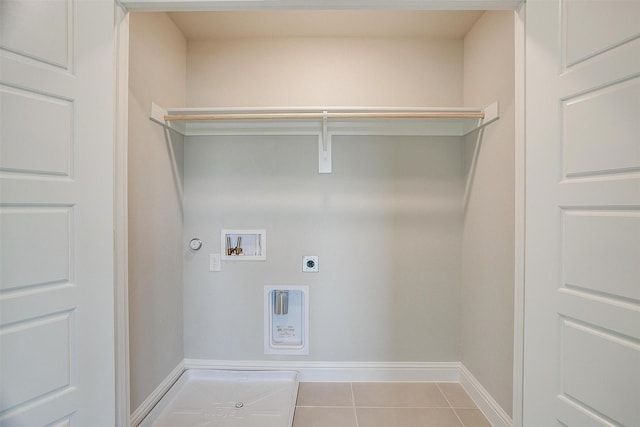 clothes washing area featuring hookup for a gas dryer, washer hookup, hookup for an electric dryer, and light tile patterned floors