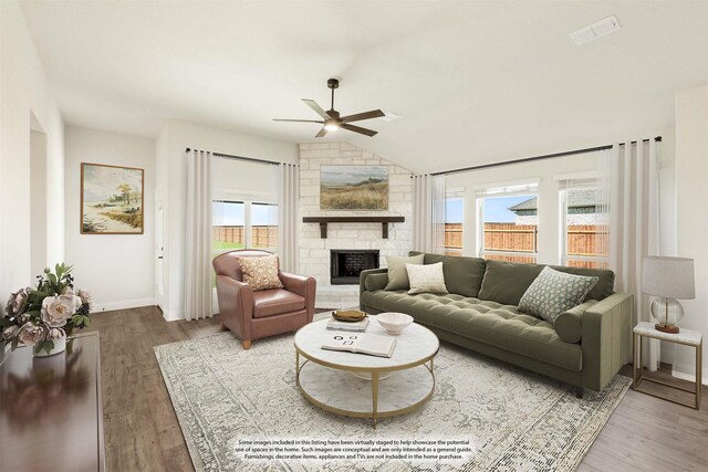 living room featuring a fireplace, hardwood / wood-style flooring, vaulted ceiling, and ceiling fan