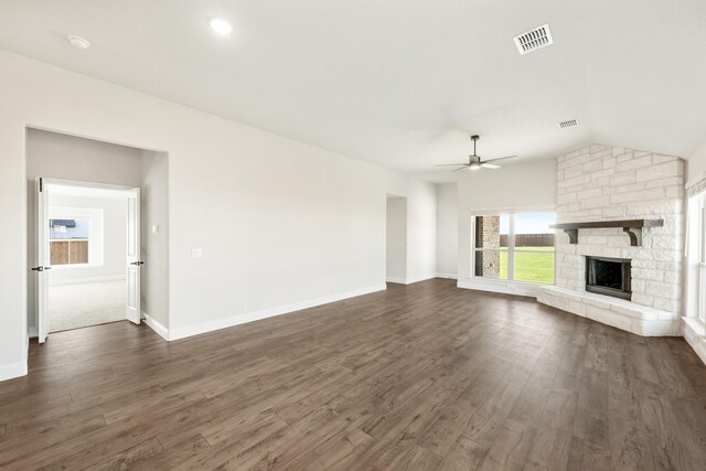 unfurnished living room with ceiling fan, a fireplace, dark wood-type flooring, and vaulted ceiling