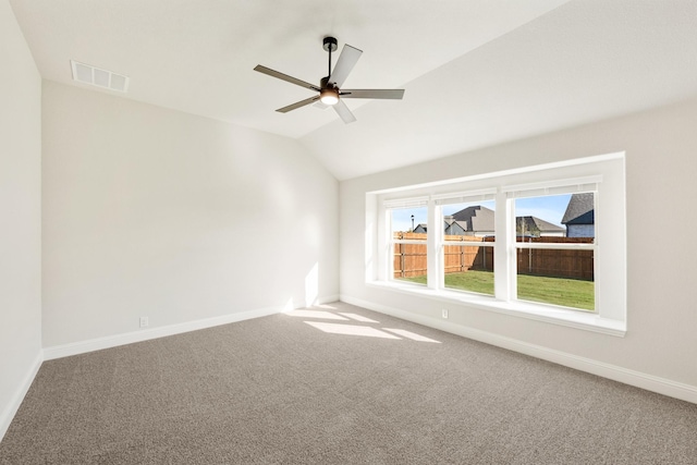 spare room with carpet flooring, ceiling fan, and lofted ceiling