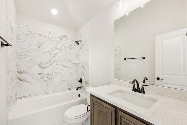 full bathroom with vanity, tiled shower / bath combo, and toilet