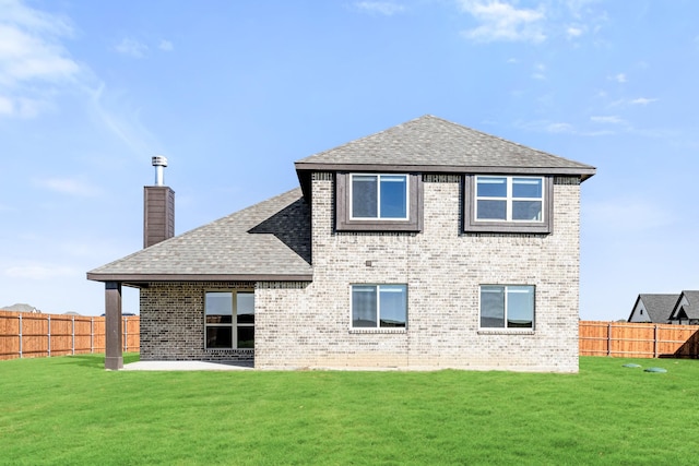 rear view of house featuring a patio area and a lawn