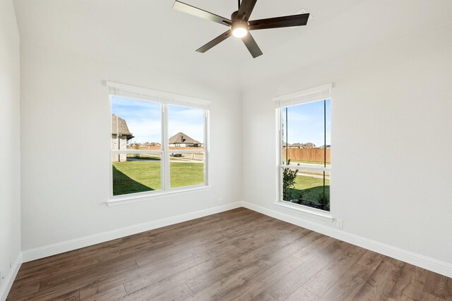 empty room with hardwood / wood-style floors and ceiling fan