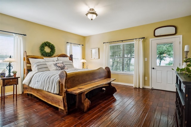 bedroom featuring dark hardwood / wood-style floors and multiple windows