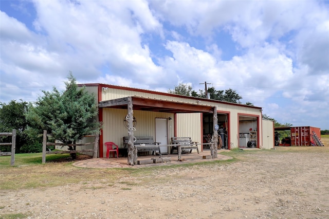 back of property with an outbuilding