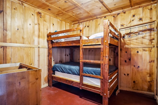 unfurnished bedroom with wood ceiling and wood walls