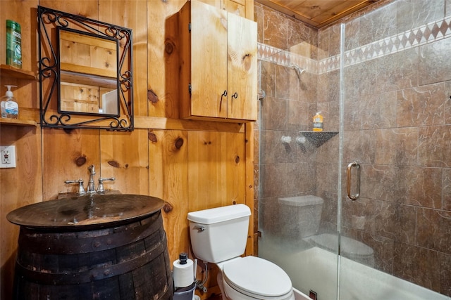 bathroom featuring wood walls and toilet