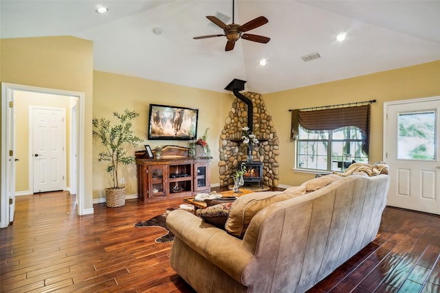 living room featuring a wood stove, lofted ceiling, hardwood / wood-style flooring, and ceiling fan