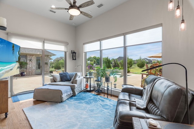 living room with hardwood / wood-style floors and ceiling fan