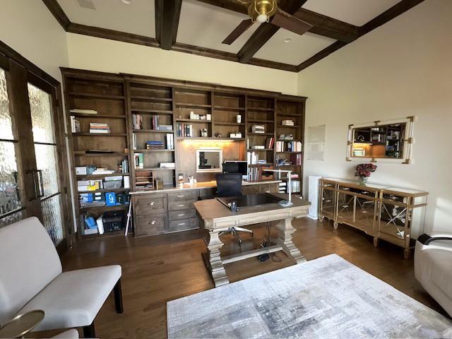 home office featuring beam ceiling, crown molding, dark wood-type flooring, ceiling fan, and coffered ceiling