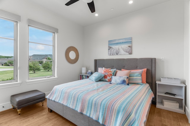 bedroom with light wood-type flooring and ceiling fan