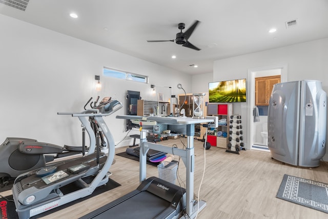 workout room featuring light wood-type flooring and ceiling fan